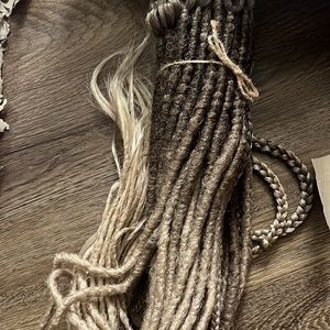 Brand new synthetic dreadlock extension. Pebble dread brand. 26 in long 50 ext.